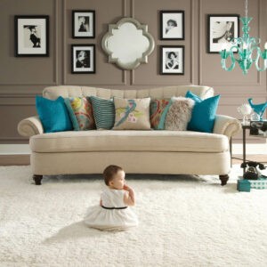 Cute baby sitting on carpet floor | Tom's Carpet & Flooring Outlet