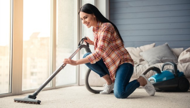 Lady cleaning carpet floor | Tom's Carpet & Flooring Outlet