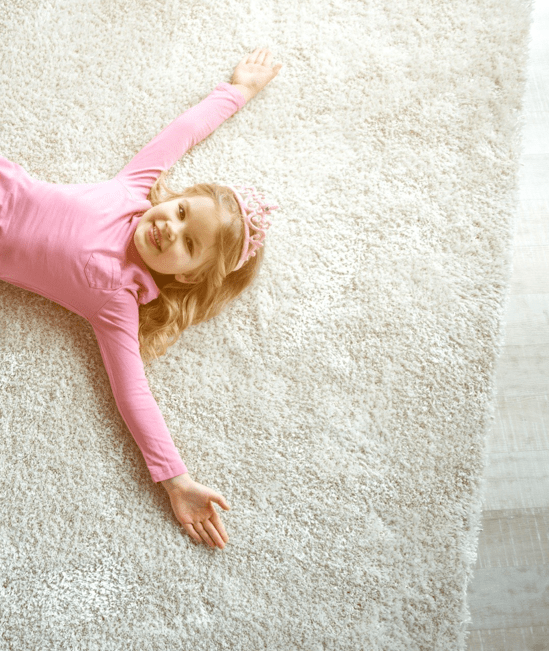 Cute girl laying on rug | Tom's Carpet & Flooring Outlet